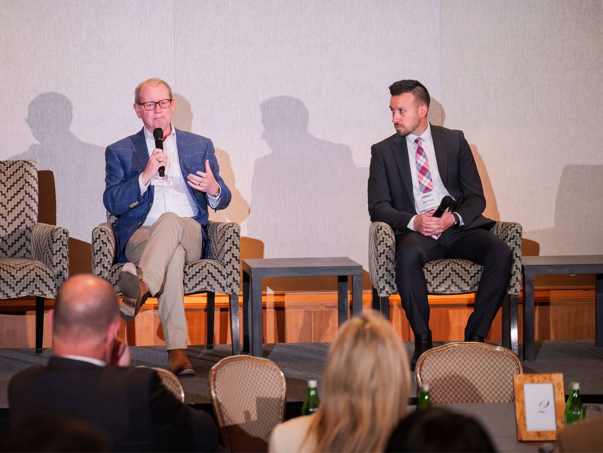 Panel discussion at hemp advocacy summit with speakers in formal attire.